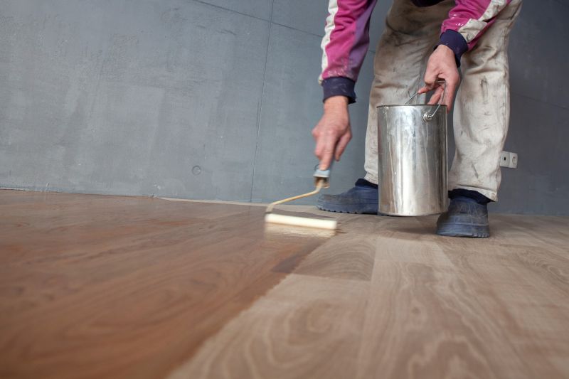 Professional wood finisher applying varnish
